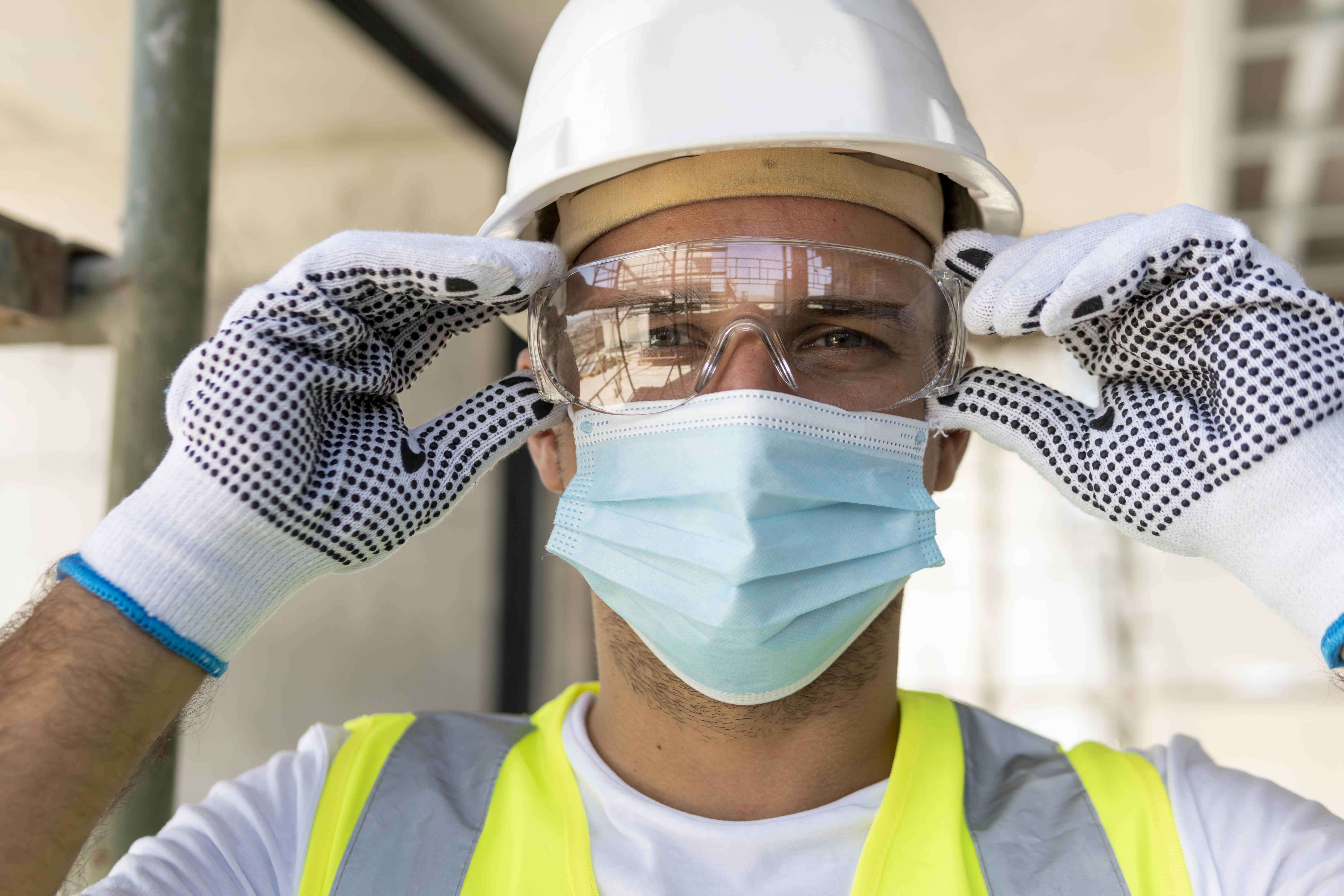Worker in hard hat and face mask